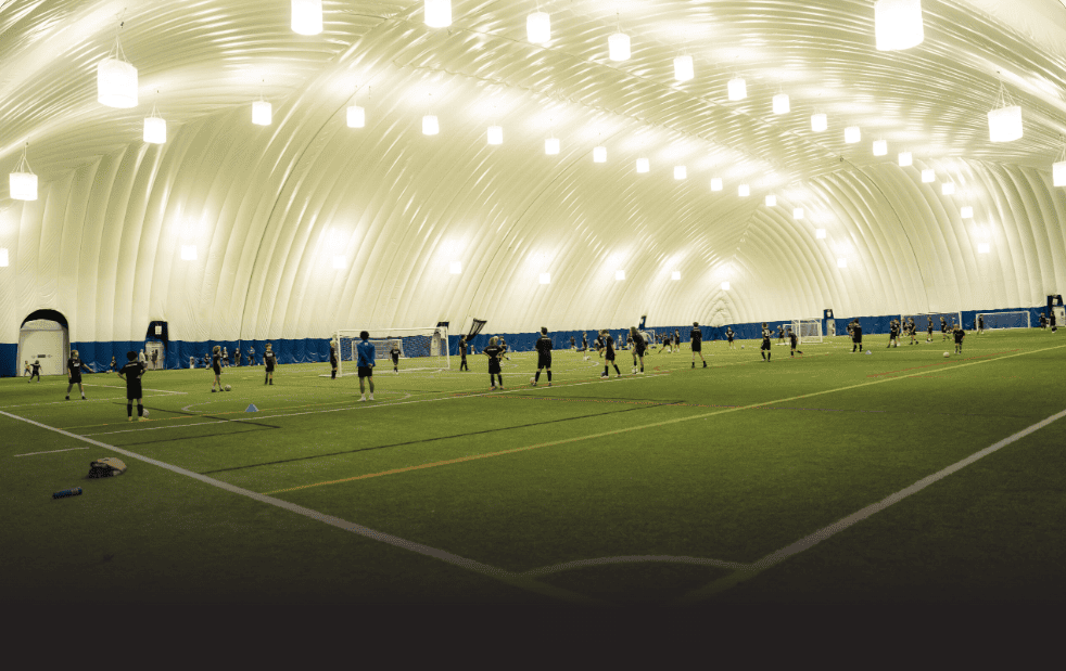 Indoor turf soccer practice inside illuminated dome